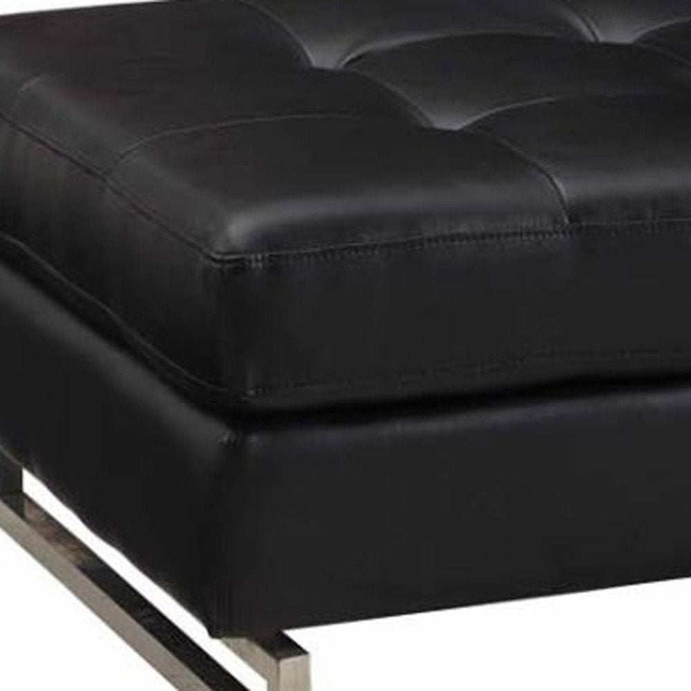 Close-up of 63" Black Tufted Faux Leather and Silver Ottoman showing silver faux leather detail.