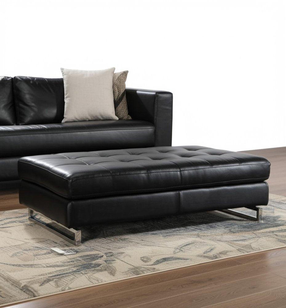 63" Black Tufted Faux Leather and Silver Ottoman. Ottoman in black faux leather.