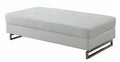 63" White and Silver Faux Leather Ottoman. Ottoman isolated on a plain white background, in a silver faux leather finish.