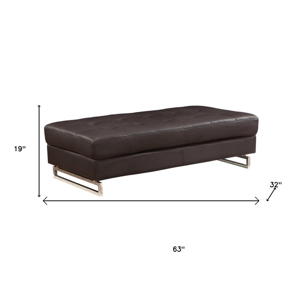 63" Brown and Silver Faux Leather Tufted Ottoman. Ottoman isolated on a plain white background, in a silver faux leather finish.