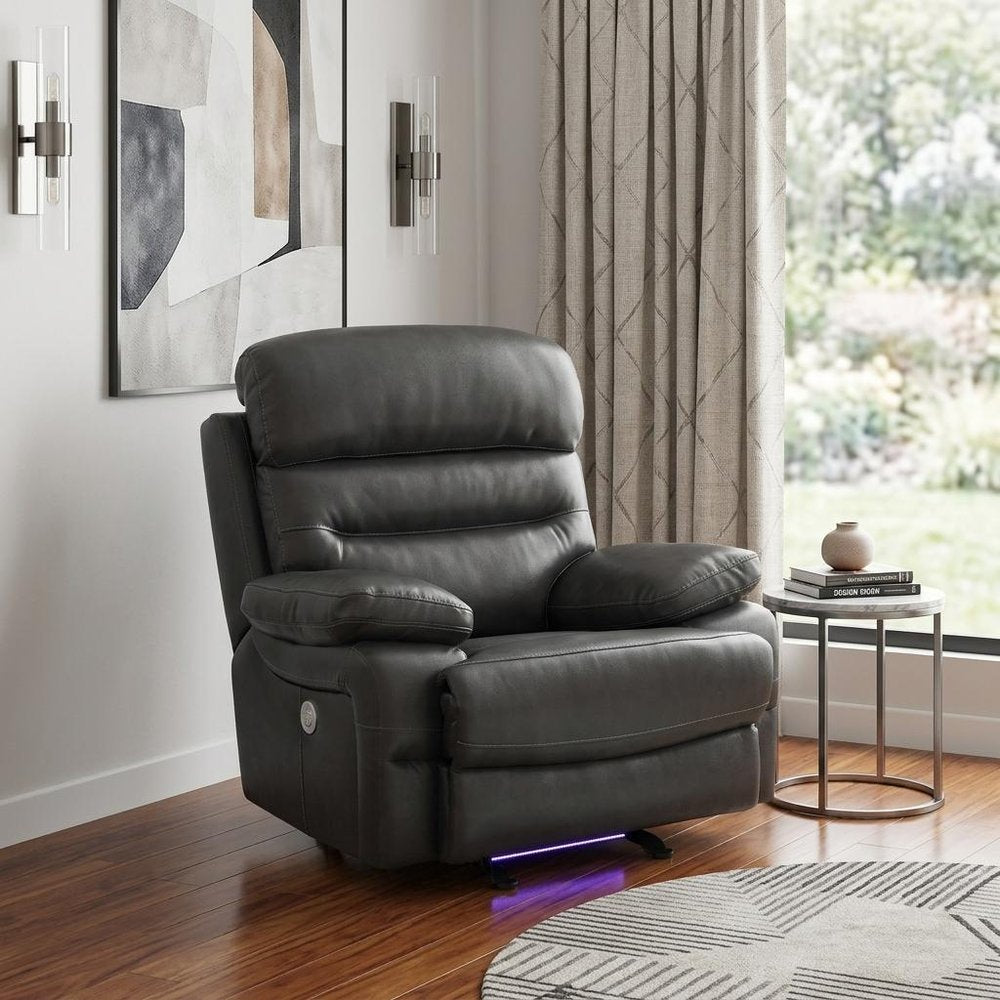 43" Grey Faux Leather Power Recliner Chair styled in a furnished interior with an off-white wall on a dark wood floor in gray faux leather.