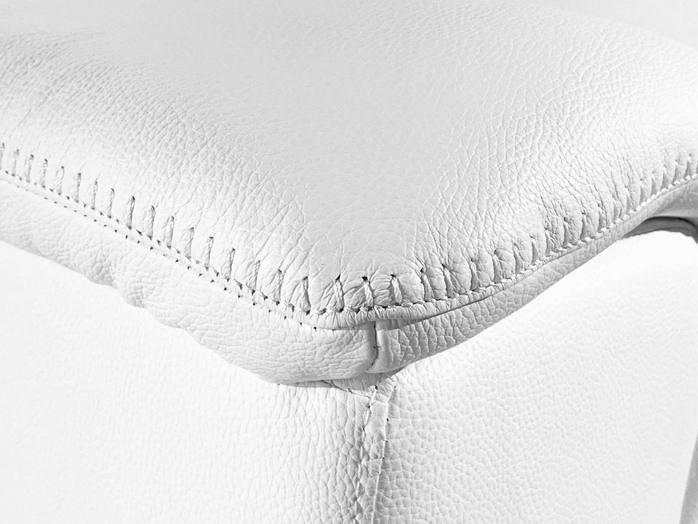 Close-up of white Italian leather upholstery on a sectional sofa, showing stitching detail and texture.