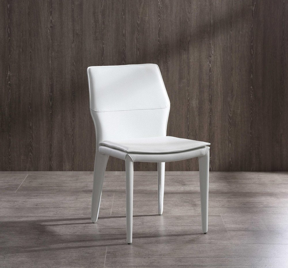 Set of Two White Slipcovered Upholstered Faux Leather Dining Side Chairs in a home interior