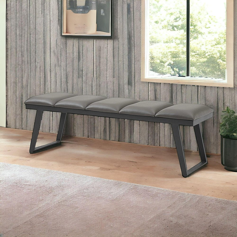57" Gray Upholstered Faux Leather Bench styled in a furnished interior with a gray wall on a blush floor.