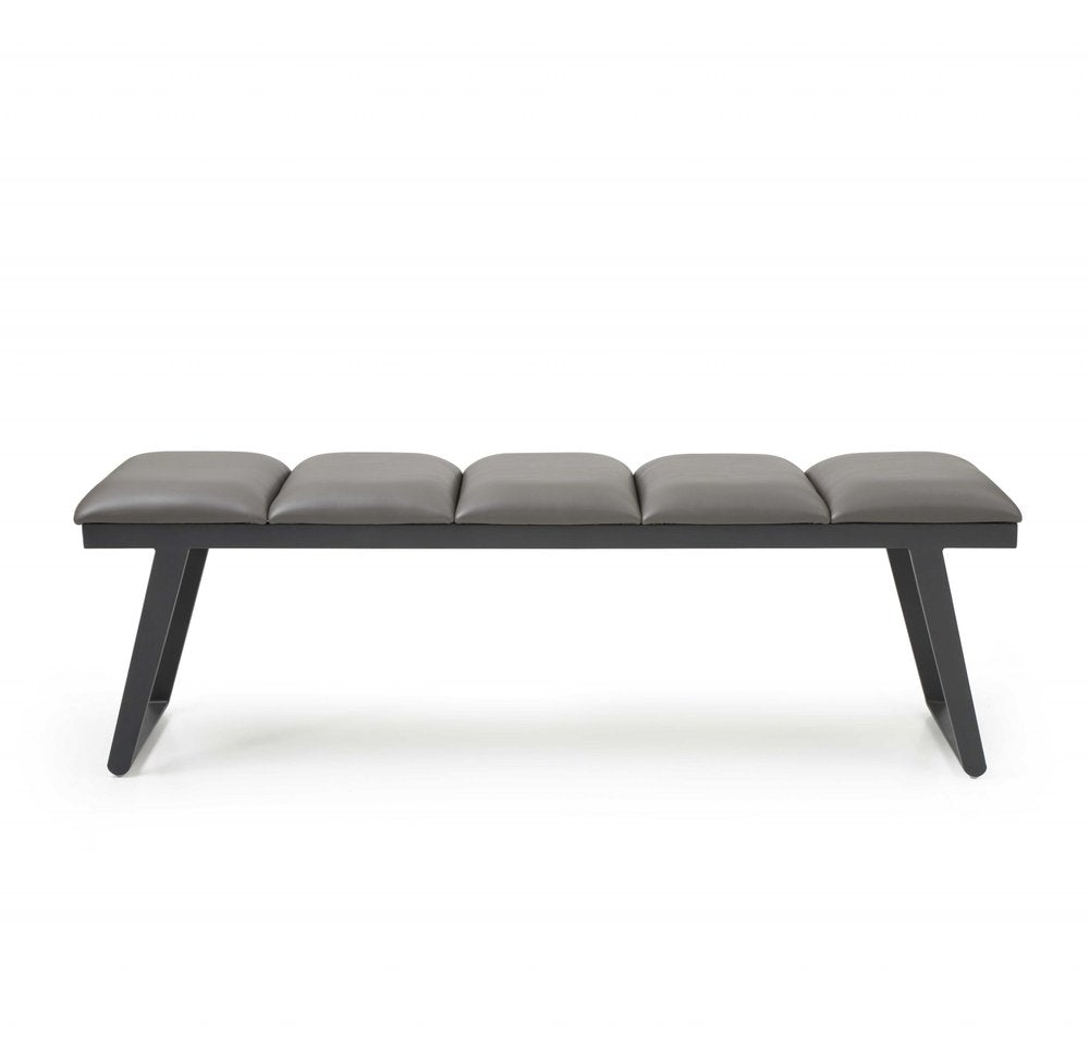 Gray upholstered faux leather bench with a black metal frame on a white background.