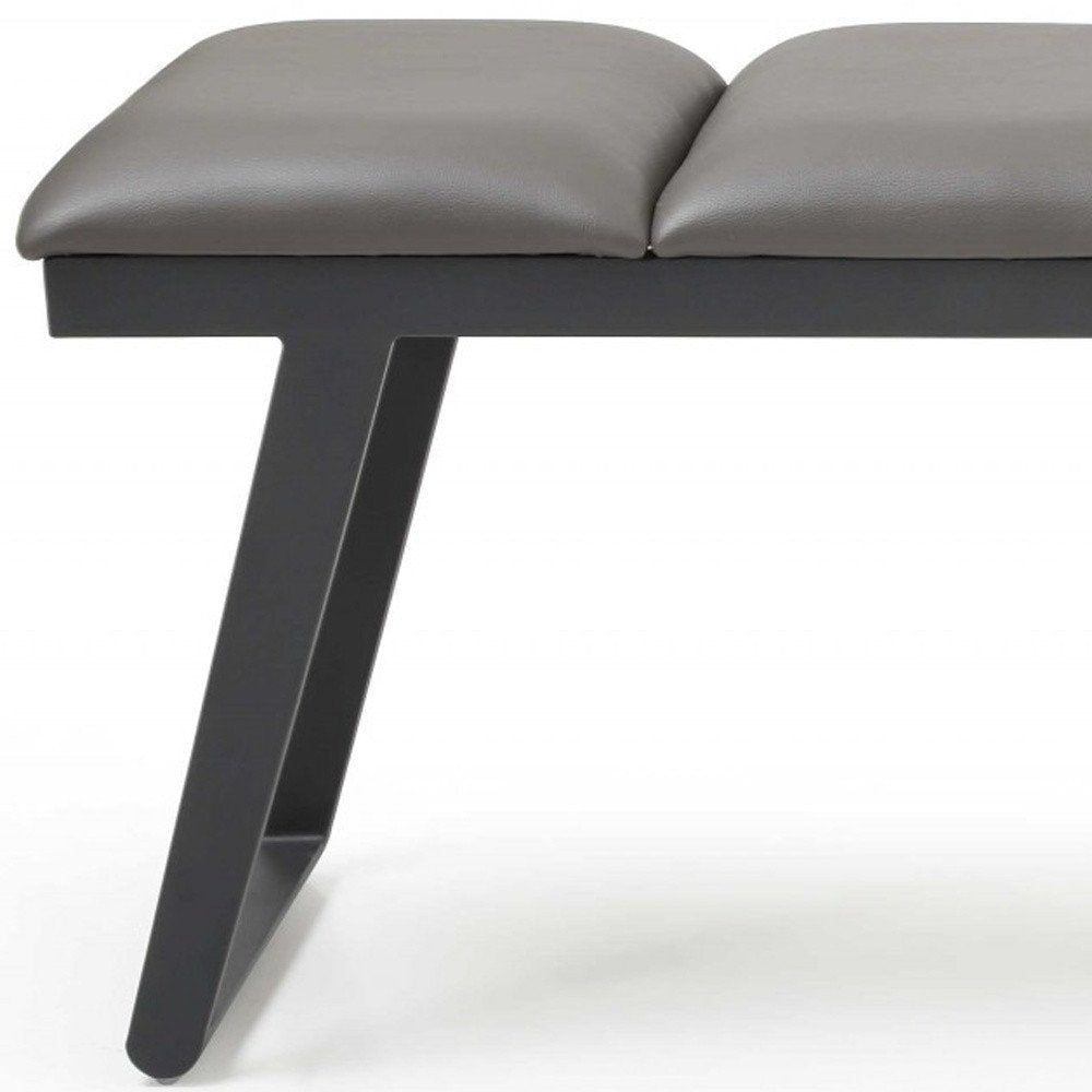 57" Gray Upholstered Faux Leather Bench. Bench isolated on a plain white background, in a gray faux leather finish.