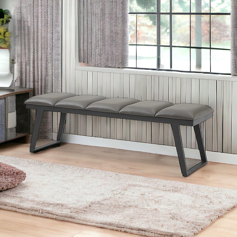 57" Gray Upholstered Faux Leather Bench styled in a furnished interior with a gray wall on a tiled floor.
