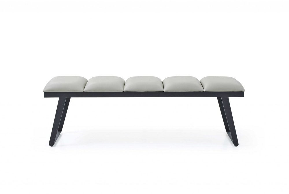 A light gray upholstered faux leather bench with black metal legs on a white background.