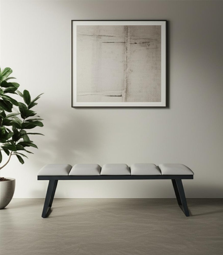 57" Light Gray and Black Upholstered Faux Leather Bench styled in a furnished interior with a gray wall on a wood floor.