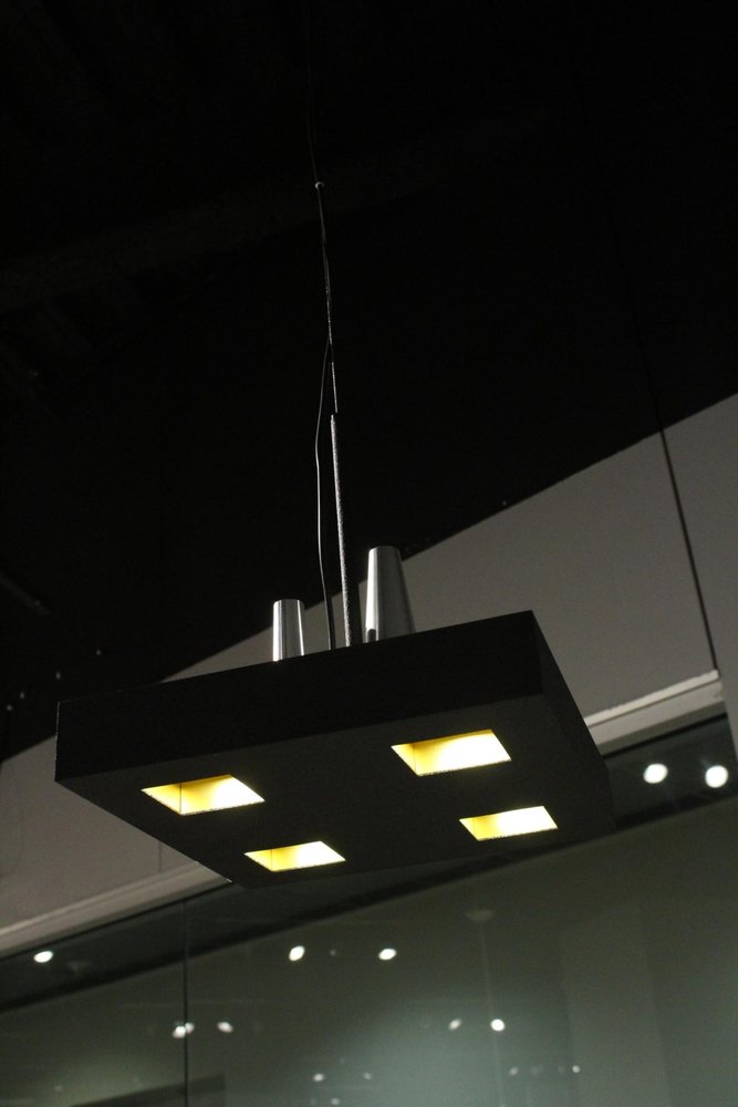 14 X 14 X 59 Black Stainless Steel Pendant Lamp photographed against a dark studio background in black.