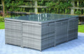 11 Piece Clear and Gray Glass Dining Set shown outdoors on a patio with greenery.