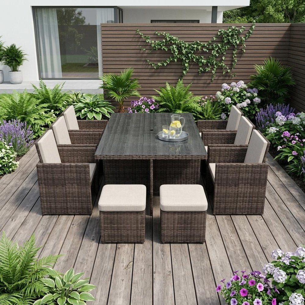11 Piece Clear and Gray Glass Dining Set shown outdoors on a patio with greenery.