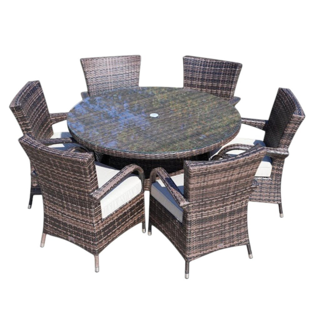 Round glass dining set with six brown wicker chairs with cream cushions on a white background.
