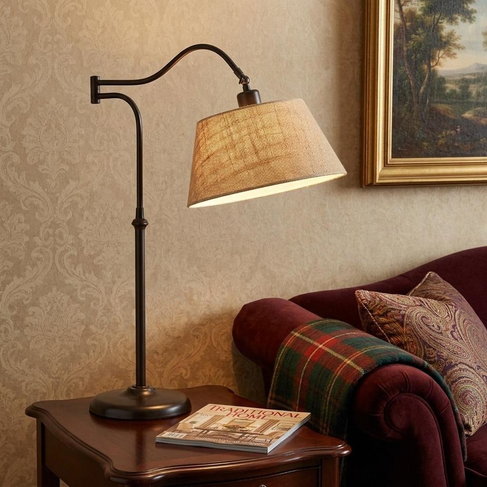 27" Black Desk Lamp With Empire Shade styled in a furnished interior with a tan wall on a black floor.