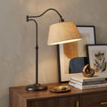 27" Black Desk Lamp With Empire Shade styled in a furnished interior with a tan wall on a dark wood floor.