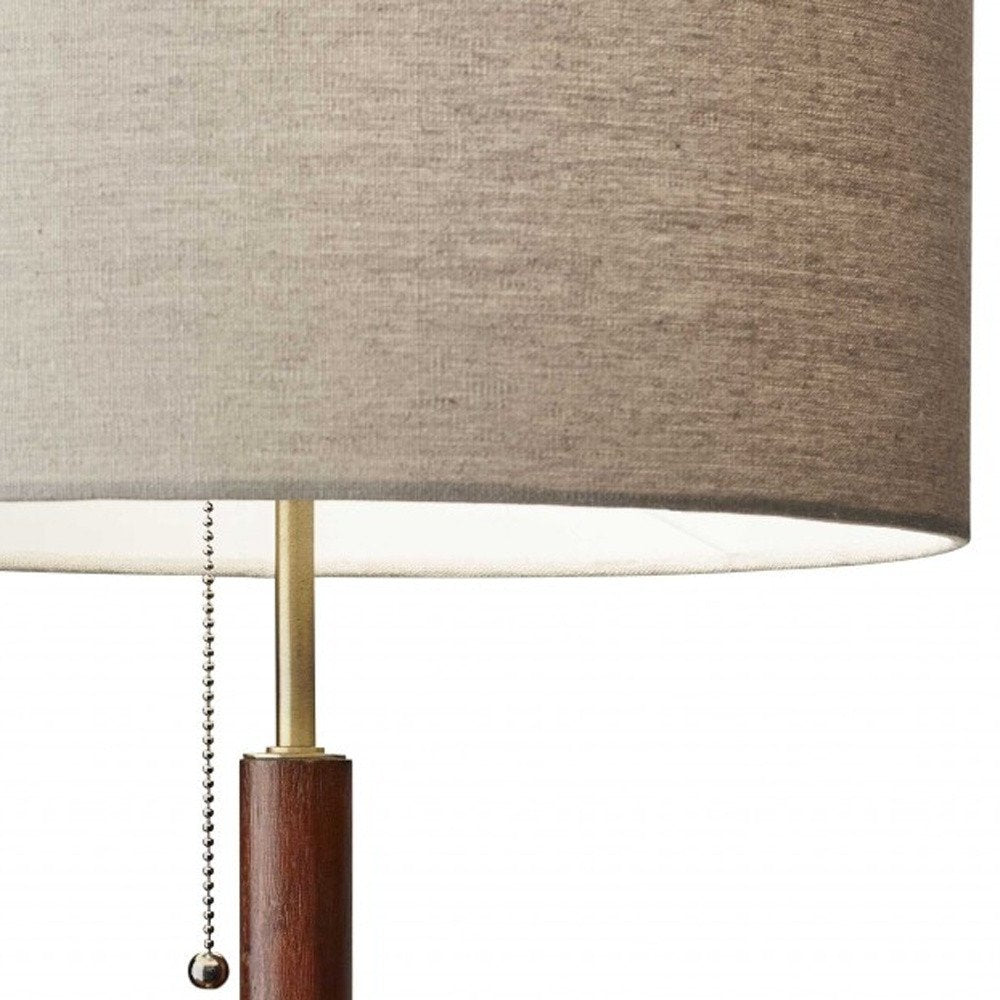 26" Antiqued Brass Solid Wood Table Lamp With Beige Drum Shade. Table lamp in beige wood.