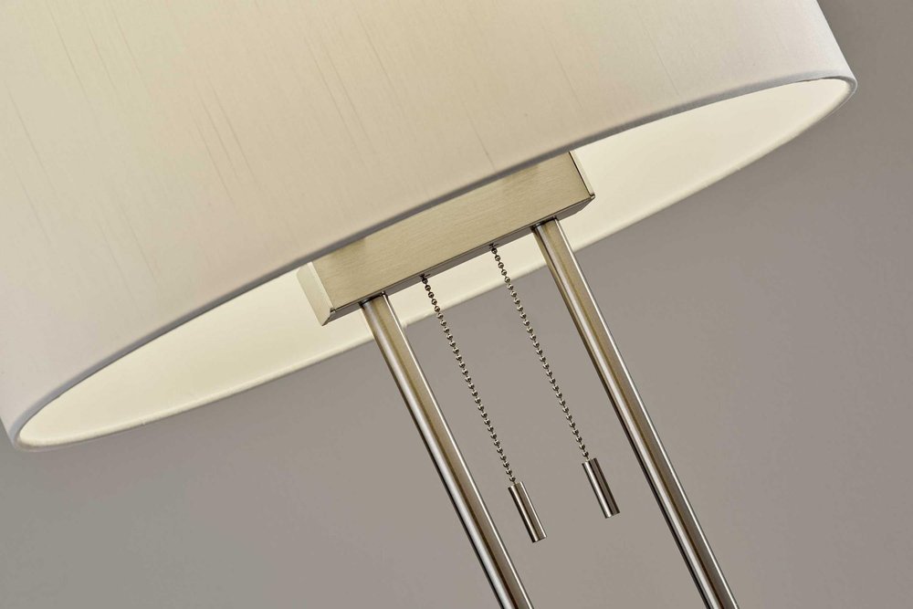 27" Silver Metal Two Light Bedside Lamp With Off White Drum Shade. Lamp in off-white metal.
