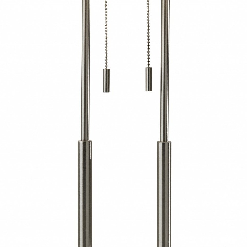 27" Silver Metal Two Light Bedside Lamp With Off White Drum Shade. Lamp isolated on a plain white background, showing a off-white metal surface.
