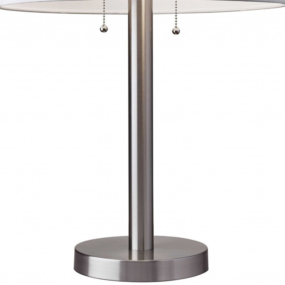 28" Silver Metal Two Light Bedside Table Lamp With White Drum Shade. Table lamp isolated on a plain white background, showing a silver metal surface.