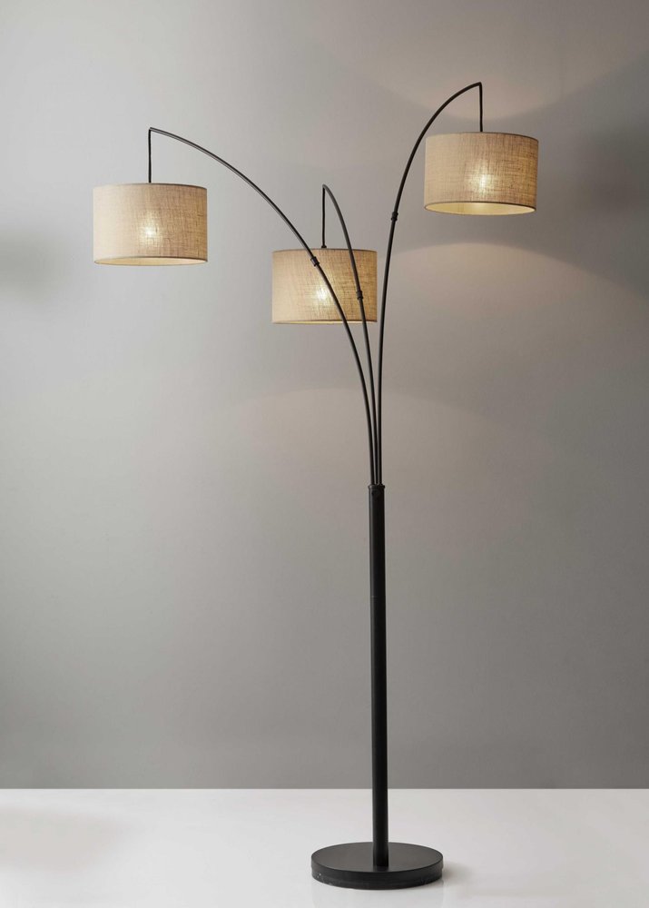 74" Silver Three Light Tree Floor Lamp With White Linen Drum Shade in a home interior