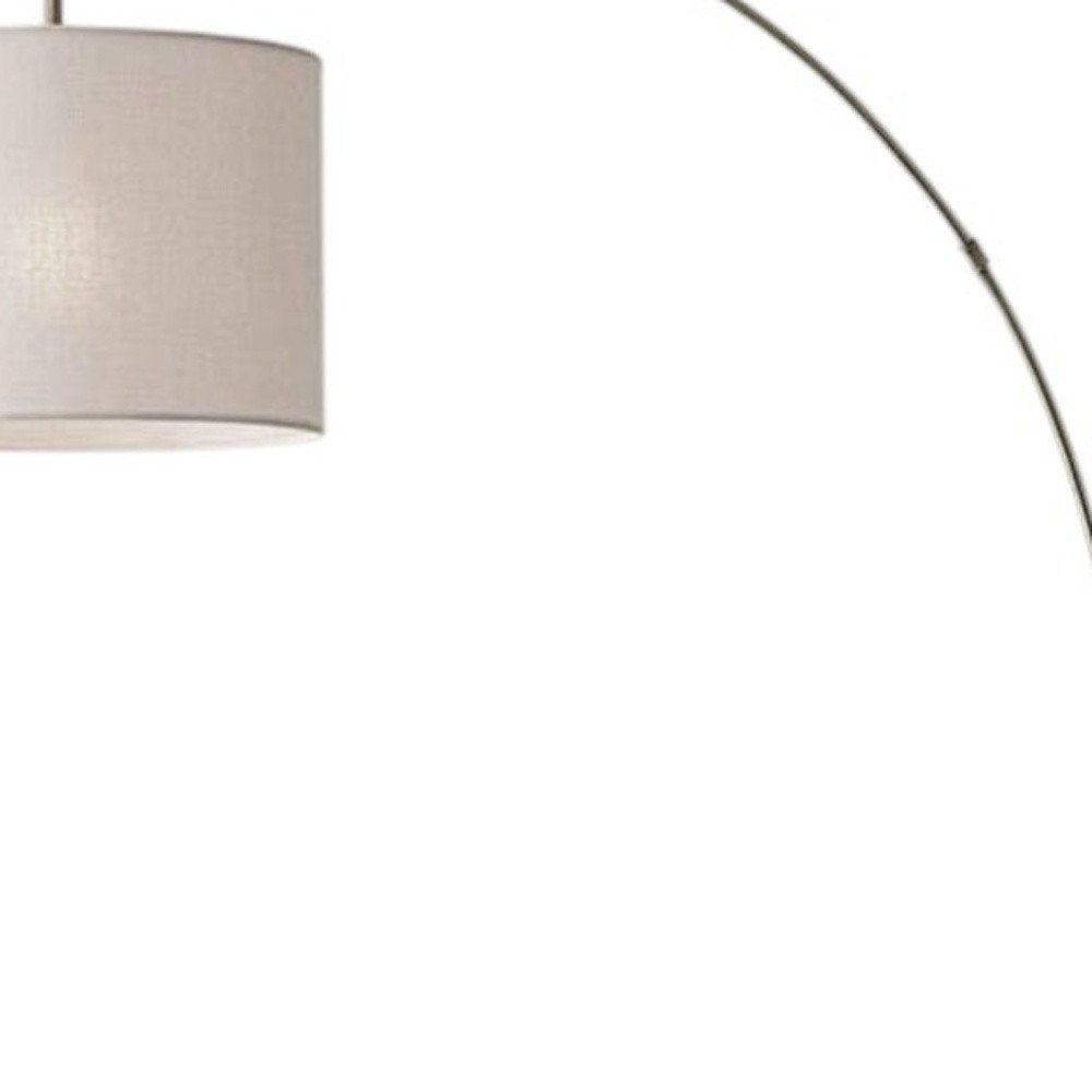 74" Brass Metal Arc Floor Lamp With Off White Linen Drum Shade on a white background