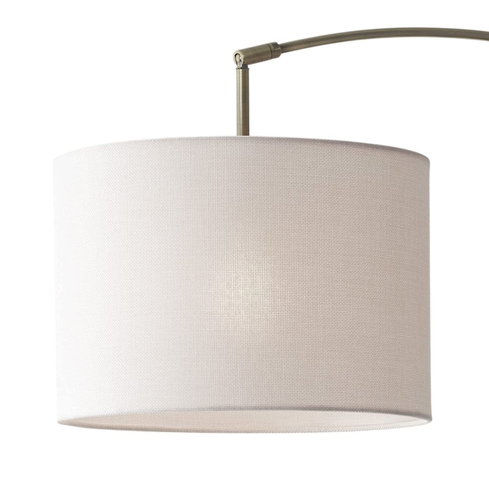 74" Brass Metal Arc Floor Lamp With Off White Linen Drum Shade on a white background