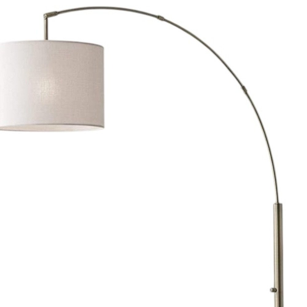 74" Brass Metal Arc Floor Lamp With Off White Linen Drum Shade on a white background