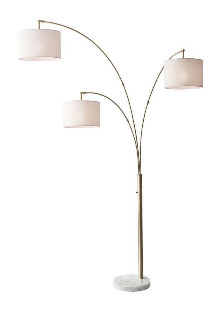 74" Brass Three Light Arc Floor Lamp With Off White Fabric Drum Shade on a white background
