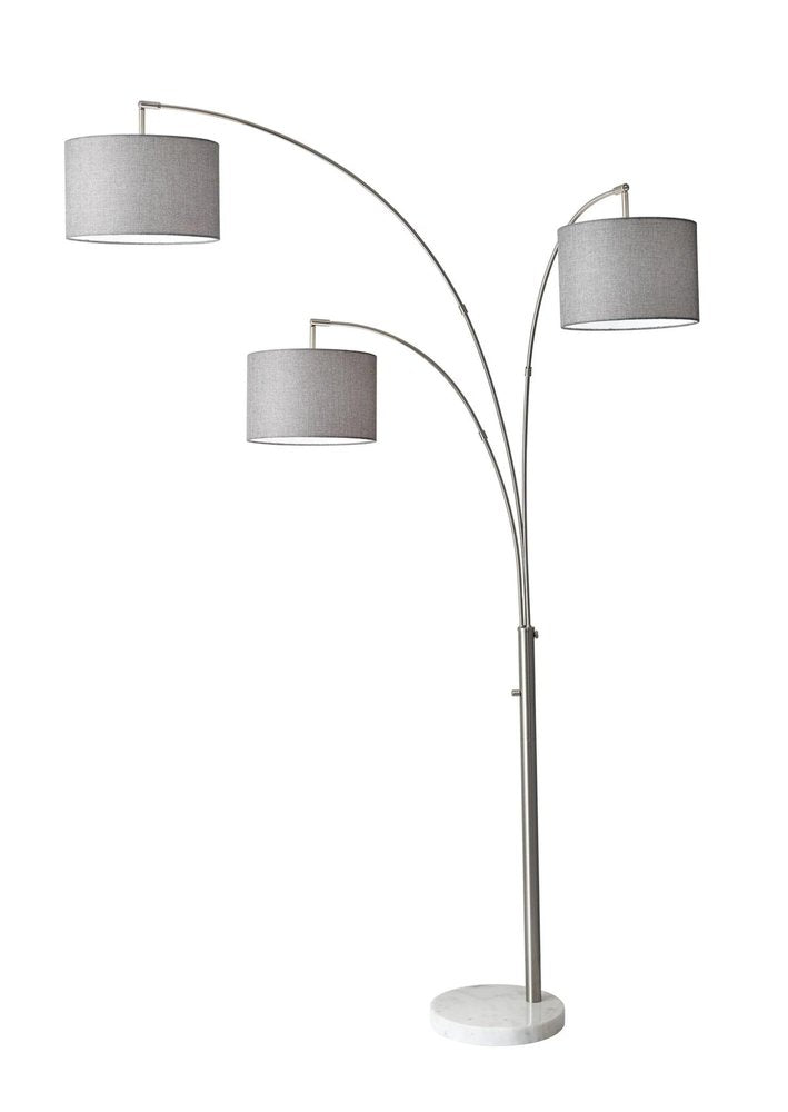 74" Brass Three Light Arc Floor Lamp With Off White Fabric Drum Shade on a white background