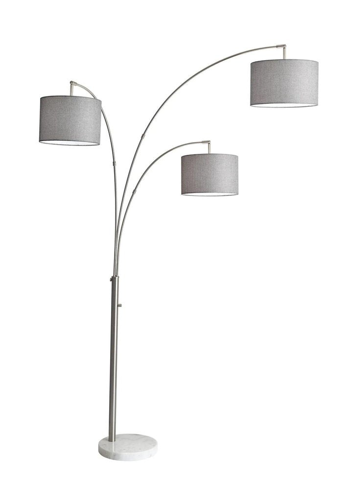 74" Brass Three Light Arc Floor Lamp With Off White Fabric Drum Shade on a white background