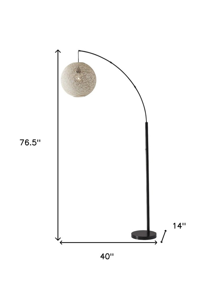 77" Antiqued Bronze Arched Floor Lamp With Groovy Beige Abstract Wicker Globe Shade on a white background