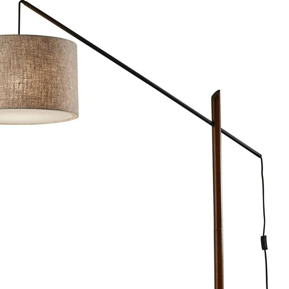 77" Beige And Black Swing Arm Floor Lamp With Beige Fabric Drum Shade on a white background