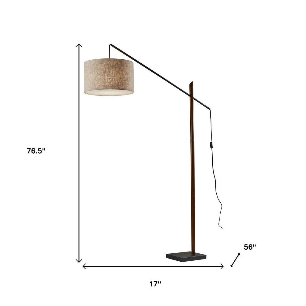 77" Beige And Black Swing Arm Floor Lamp With Beige Fabric Drum Shade on a white background