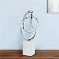 18" Silver and White Marble and Aluminum Sculpture shown outdoors on an outdoor setting.