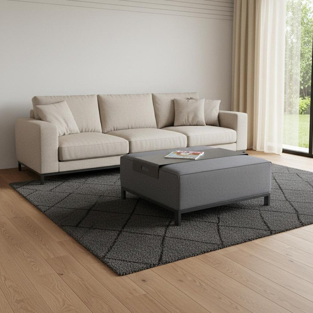 40" Gray Linen Cocktail Ottoman styled in a furnished interior with a light gray wall on a wood floor.