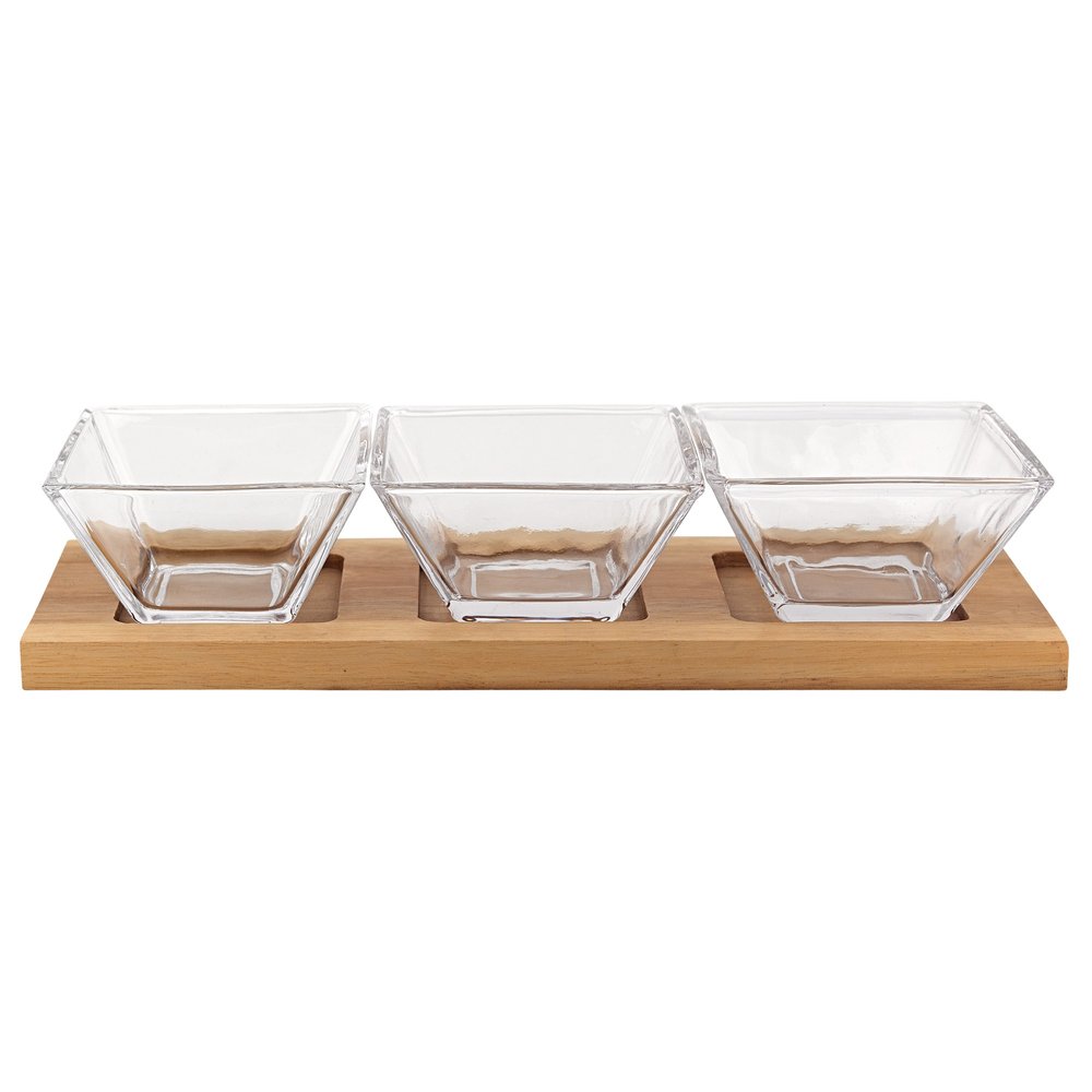 Three clear glass square condiment bowls on a natural solid wood tray.