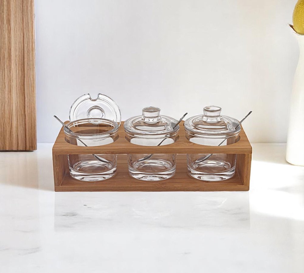 6 Mouth Blown Crystal Jam Set With 3 Glass Jars And Spoons On A Wood Stand. Kitchen accessory isolated on a plain white background, showing a glass surface.