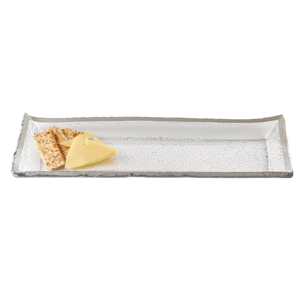 Rectangular clear glass serving tray with textured surface and silver rim, holding crackers and cheese on a white background.