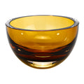Amber mouth blown crystal bowl with thick walls on a white background.