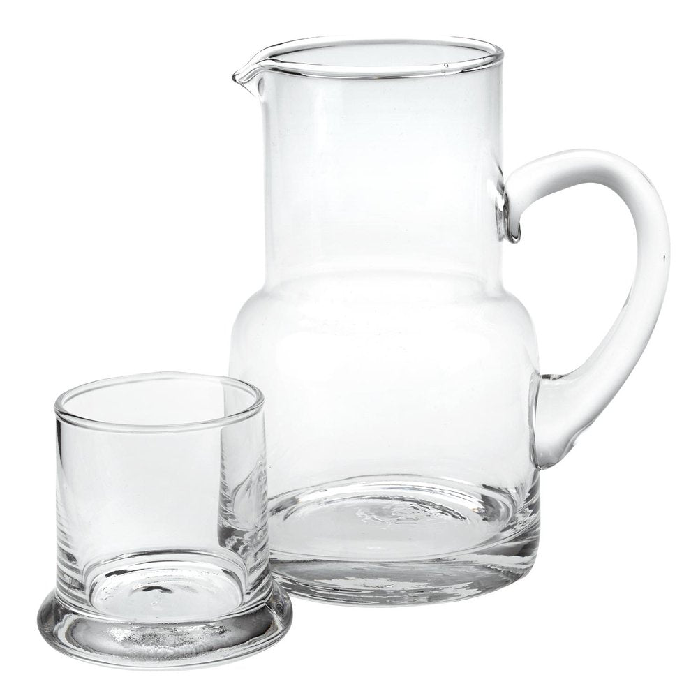Clear crystal glass carafe and stemless drinking glass set on a white background