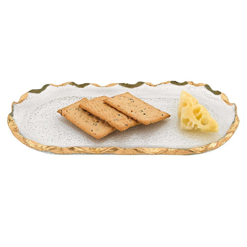 Glass oval platter with gold leaf edge, serving three crackers and a wedge of Swiss cheese on a white background.
