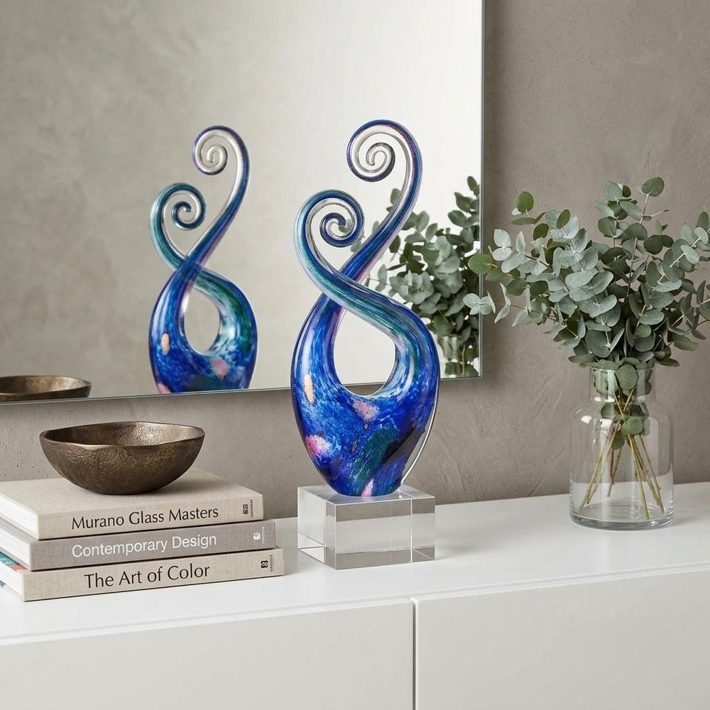 12" Blue and Green Murano Glass Modern Abstract Tabletop Sculpture styled in a furnished interior with a tan wall on a off-white floor.