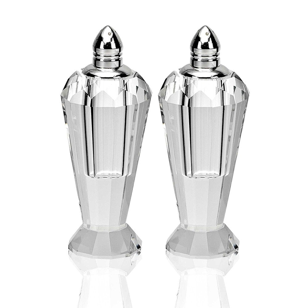 Two clear crystal geometric pepper shakers with silver tops on a white background.