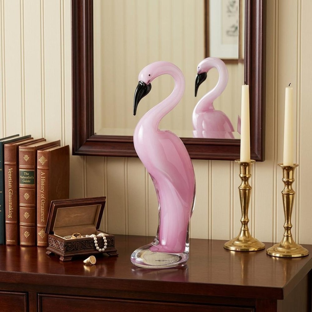 15" Pink Murano Glass Flamingo Figurine Tabletop Sculpture styled in a furnished interior with a cream wall on a black floor.