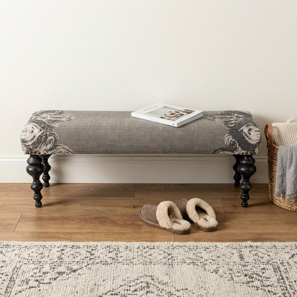 Cropped view of 55" Gray and Black Upholstered Cotton Blend Floral Distressed Bench focusing on the cotton surface.