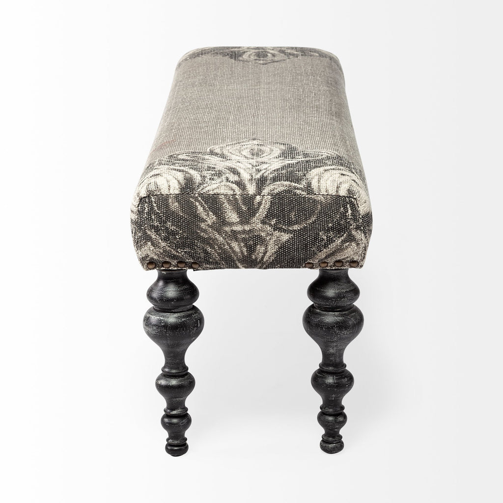 55" Gray and Black Upholstered Cotton Blend Floral Distressed Bench. Bench isolated on a plain white background, finished in black cotton.