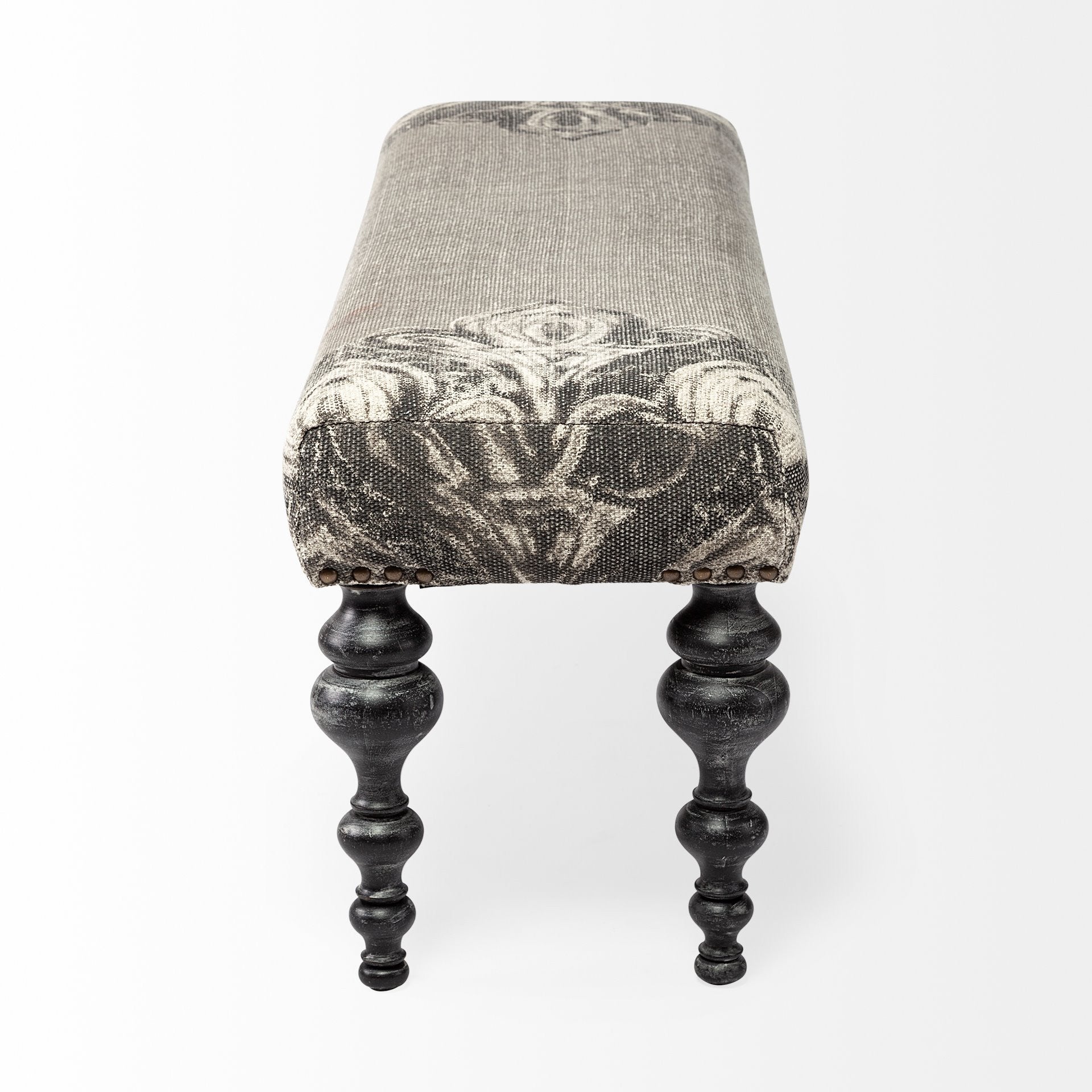 55" Gray and Black Upholstered Cotton Blend Floral Distressed Bench. Bench isolated on a plain white background, finished in black cotton.