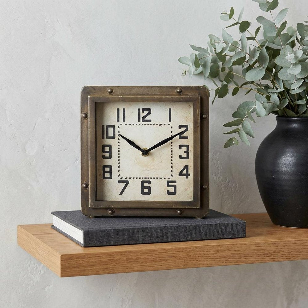 Square Bronze Toned Metal Desk Table Clock With Traditional Black Numbers And Hands in a home interior