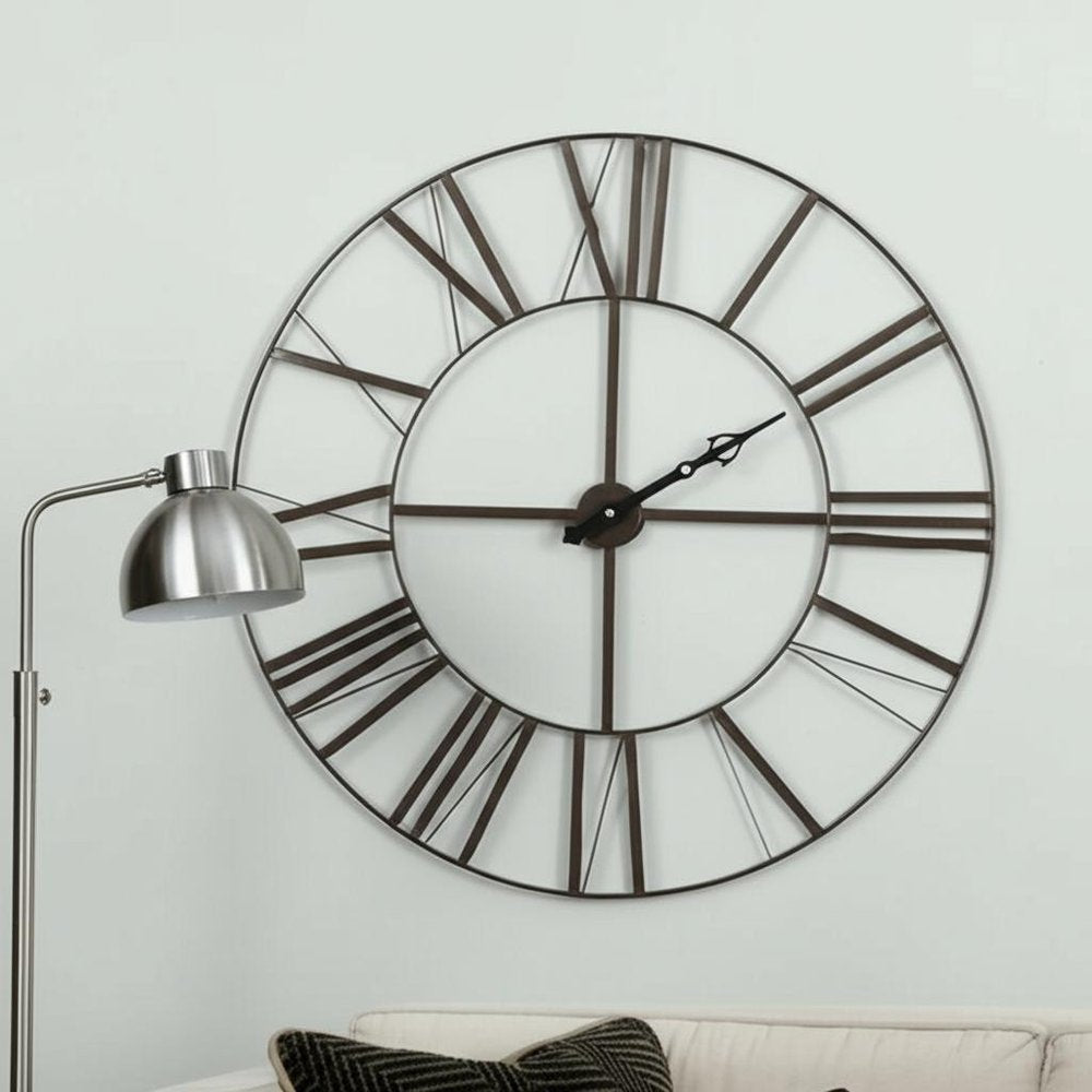 50" Circle Black Metal Skeleton Wall Clock. Wall clock isolated on a plain white background, showing a metal surface.