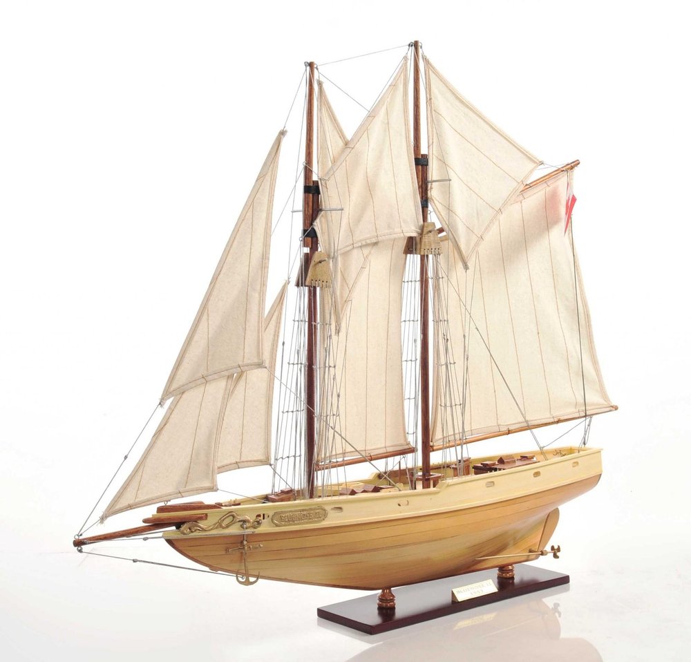 24" Brown Solid Wood Hand Painted Model Boat. Home product isolated on a plain white background, finished in brown wood.